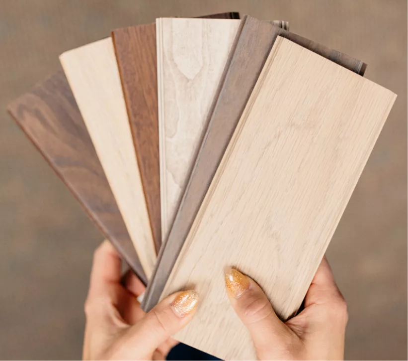 Designer holding wood and finish samples