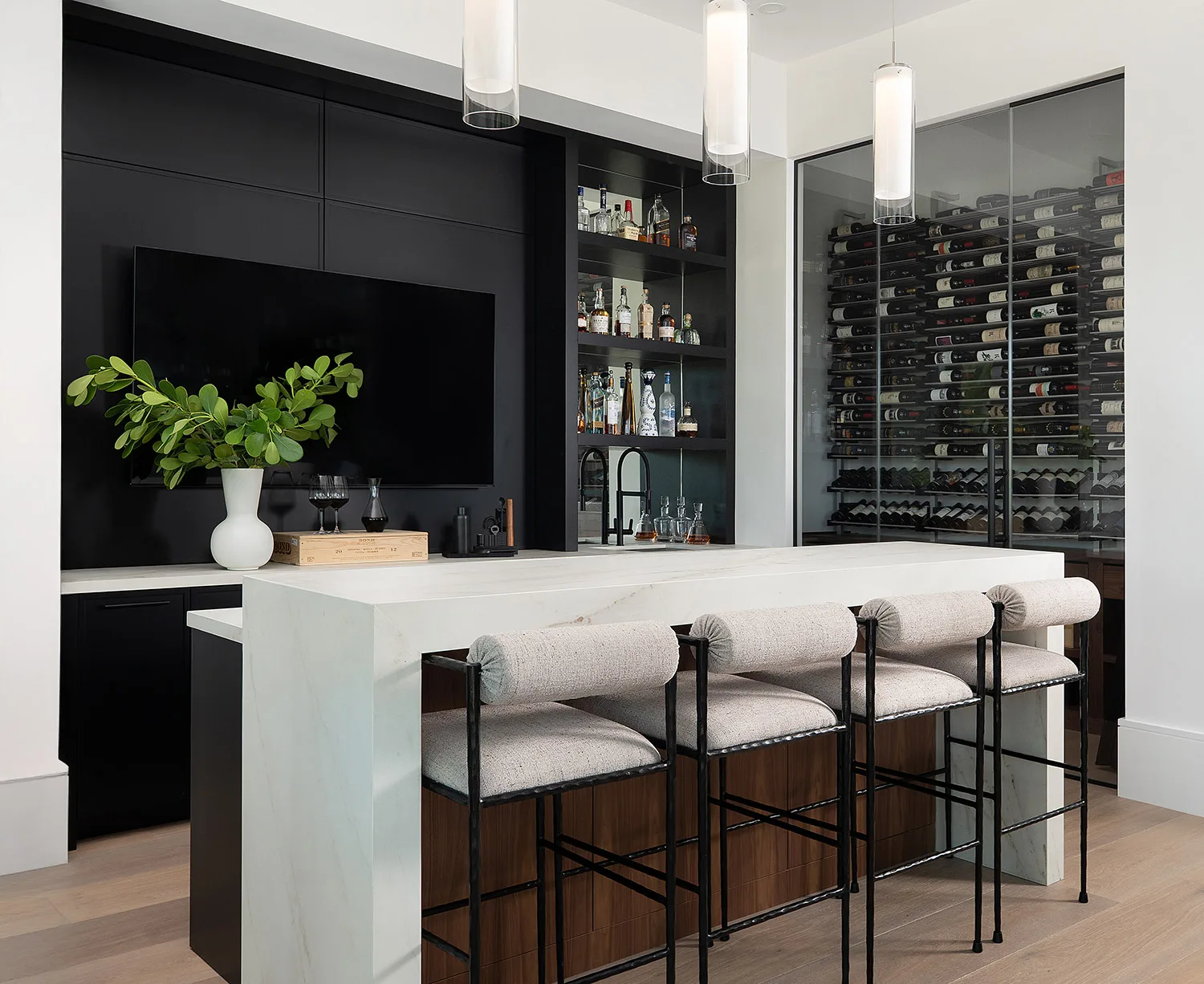 Island with stools and custom wine storage cabinets