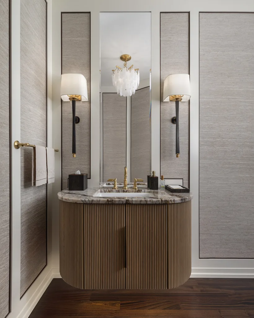 Custom bathroom vanity with vertical textures and brass faucet