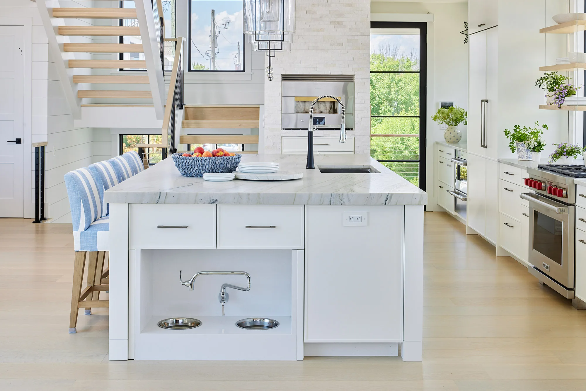 Custom built in kitchen cabinets with dog water and food bowls and custom faucet