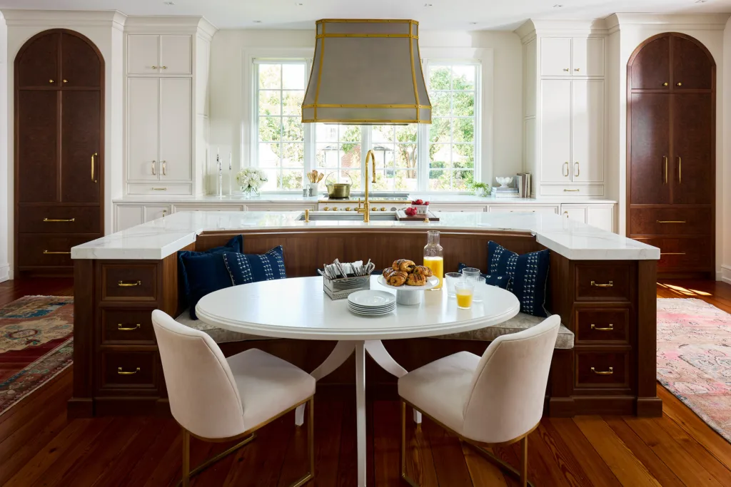 White painted custom cabinets with dark stained accent doors and U shaped island